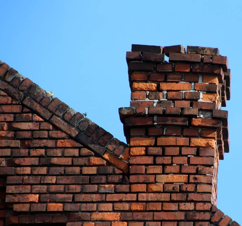 Damaged chimney on an Eastpointe home showing cracks and missing mortar